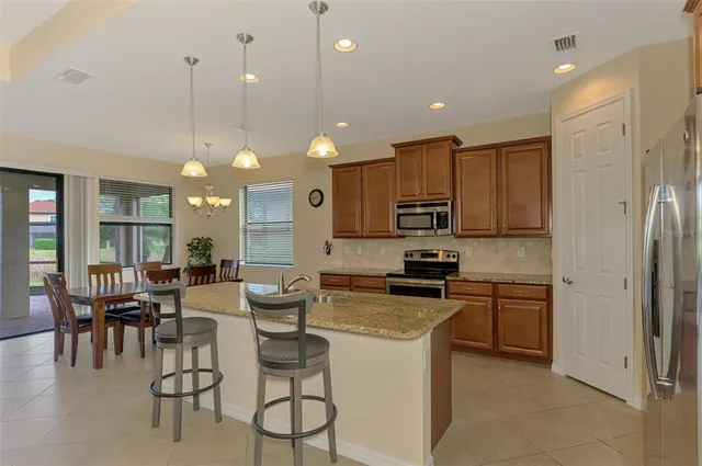 a view of a dining room that has a lot of furniture and a large window