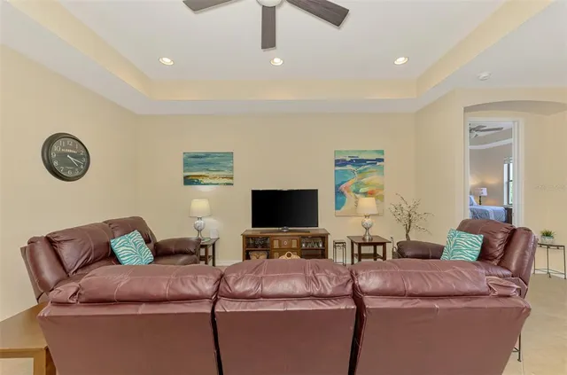a bedroom with a bed and a flat tv screen on dresser