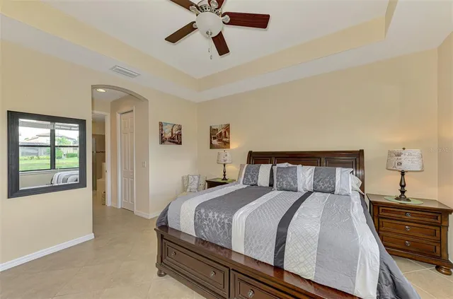 a bathroom with a granite countertop sink a large mirror and a shower