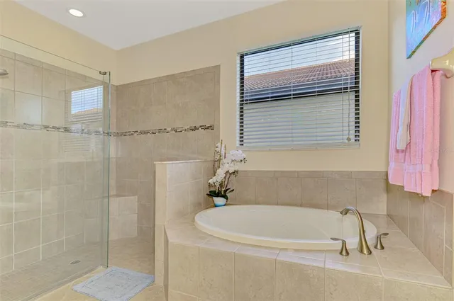 a bathroom with a granite countertop sink toilet mirror and shower