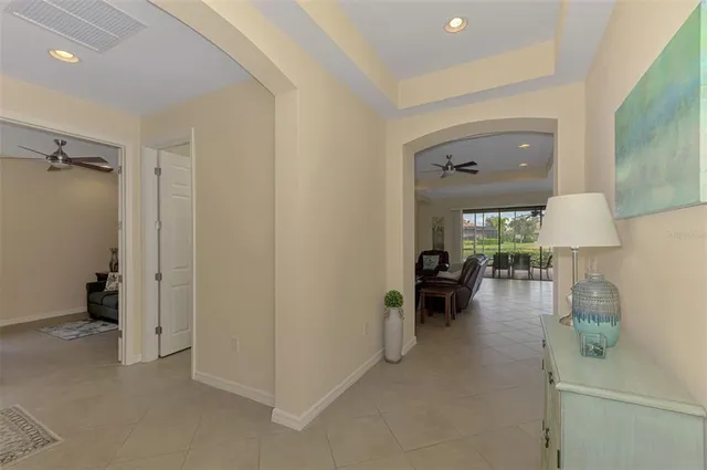 a view of a white house with a yard and potted plants