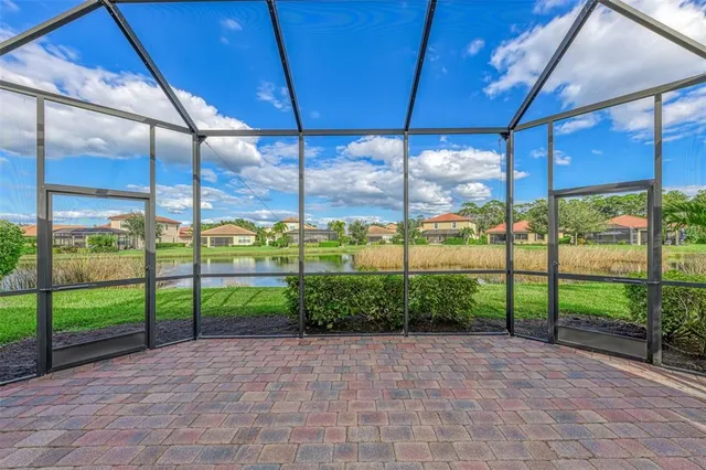 a view of a chairs and table in the patio with a lake view