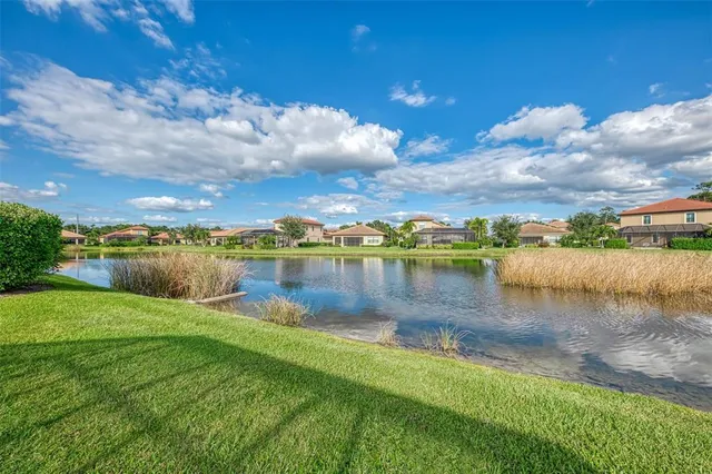 a view of a house with swimming pool and sitting area