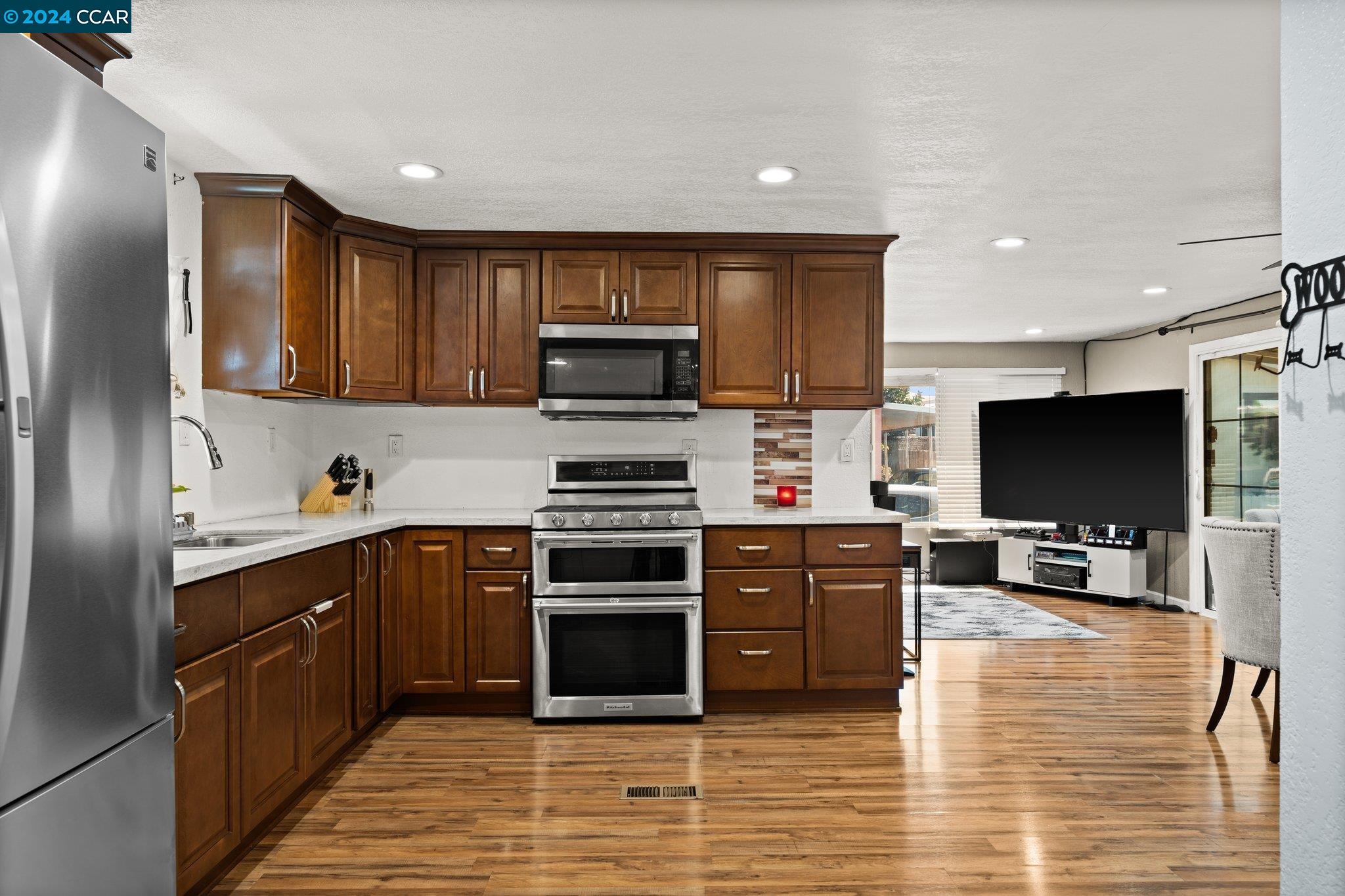 55 Pacifica Avenue, Unit 51 Bay Point, CA 94565 - Photo 12 of 35 a kitchen with stainless steel appliances wooden cabinets and a stove top oven