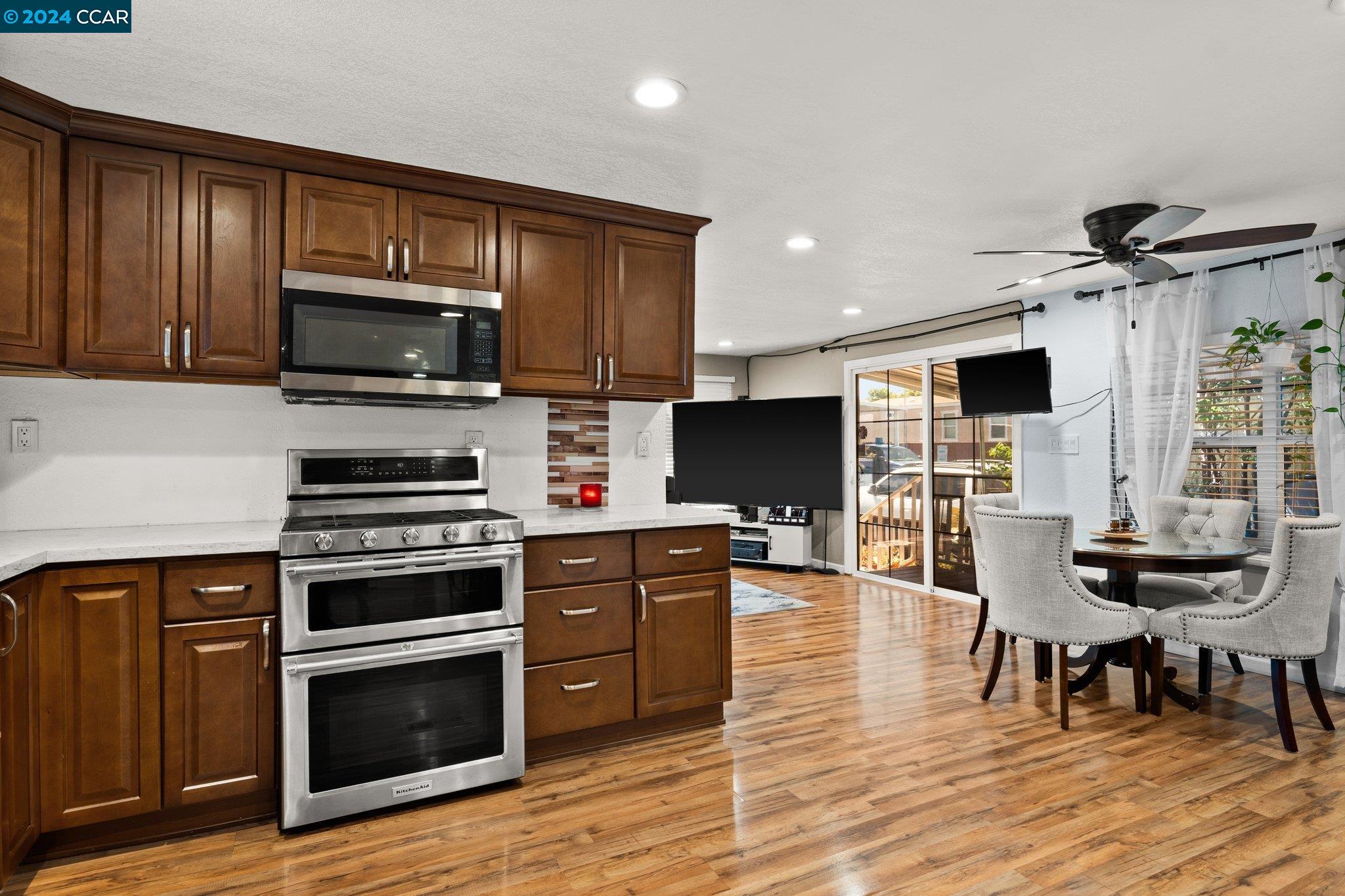 55 Pacifica Avenue, Unit 51 Bay Point, CA 94565 - Photo 14 of 35 a kitchen with stainless steel appliances a stove a sink a microwave a refrigerator and cabinets