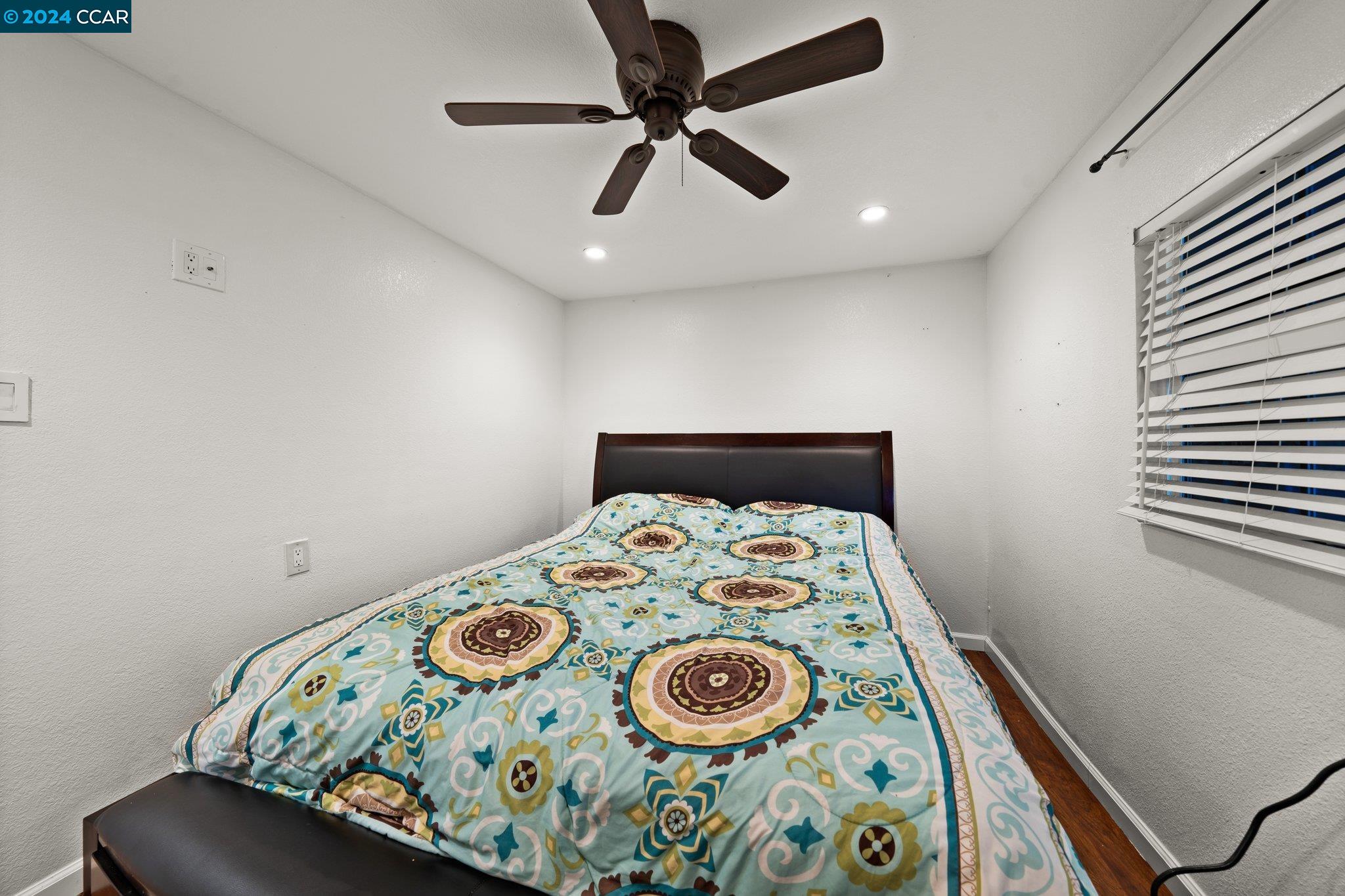 55 Pacifica Avenue, Unit 51 Bay Point, CA 94565 - Photo 16 of 35 a bedroom with a bed and a table in it