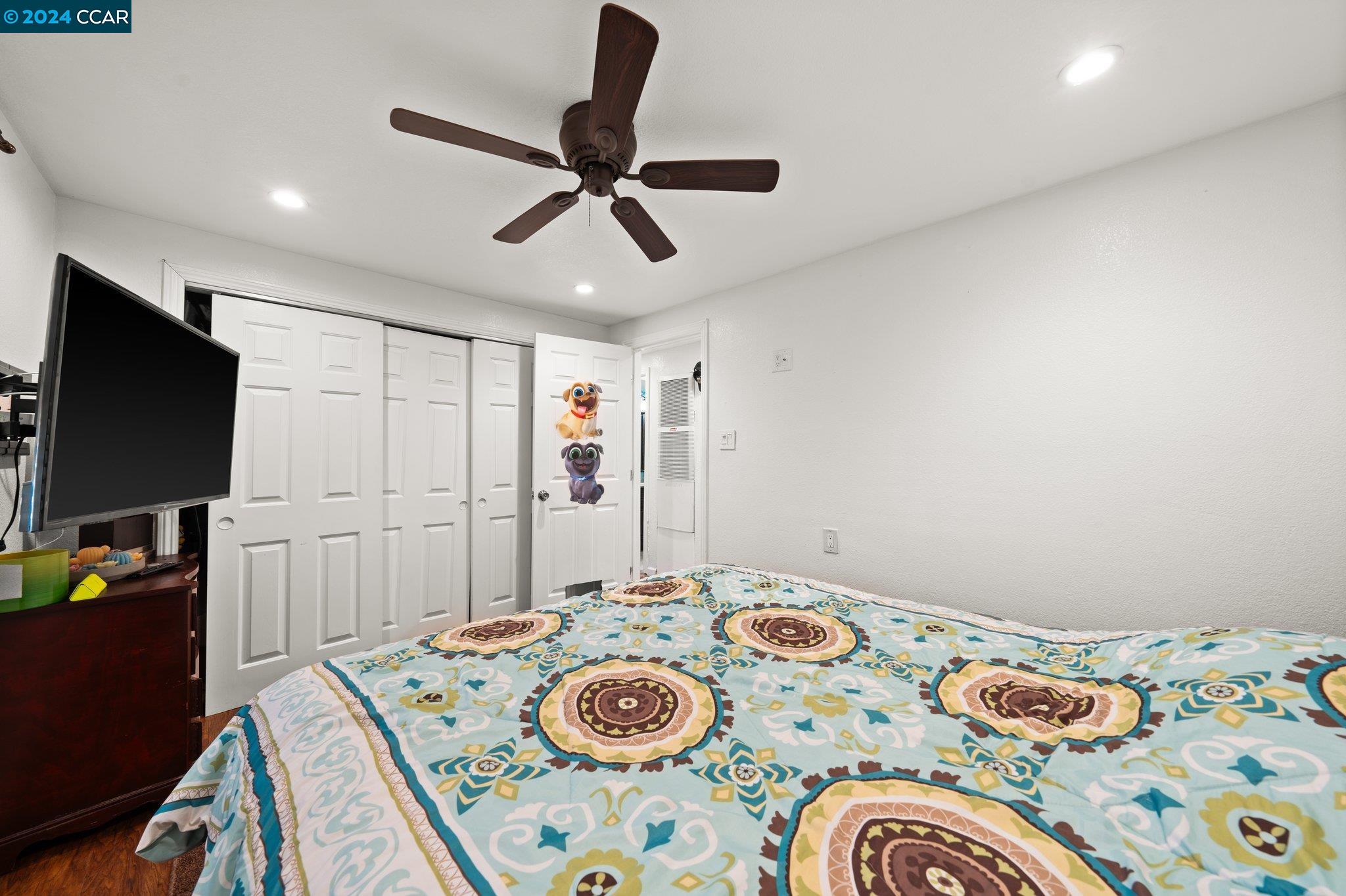 55 Pacifica Avenue, Unit 51 Bay Point, CA 94565 - Photo 17 of 35 a bedroom with a bed and a flat screen tv