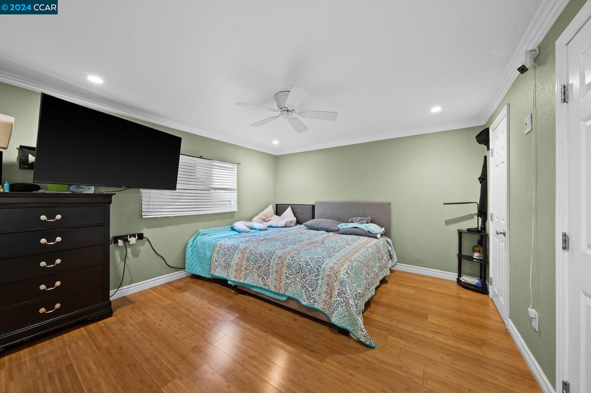 55 Pacifica Avenue, Unit 51 Bay Point, CA 94565 - Photo 19 of 35 a bedroom with a bed and a flat screen tv