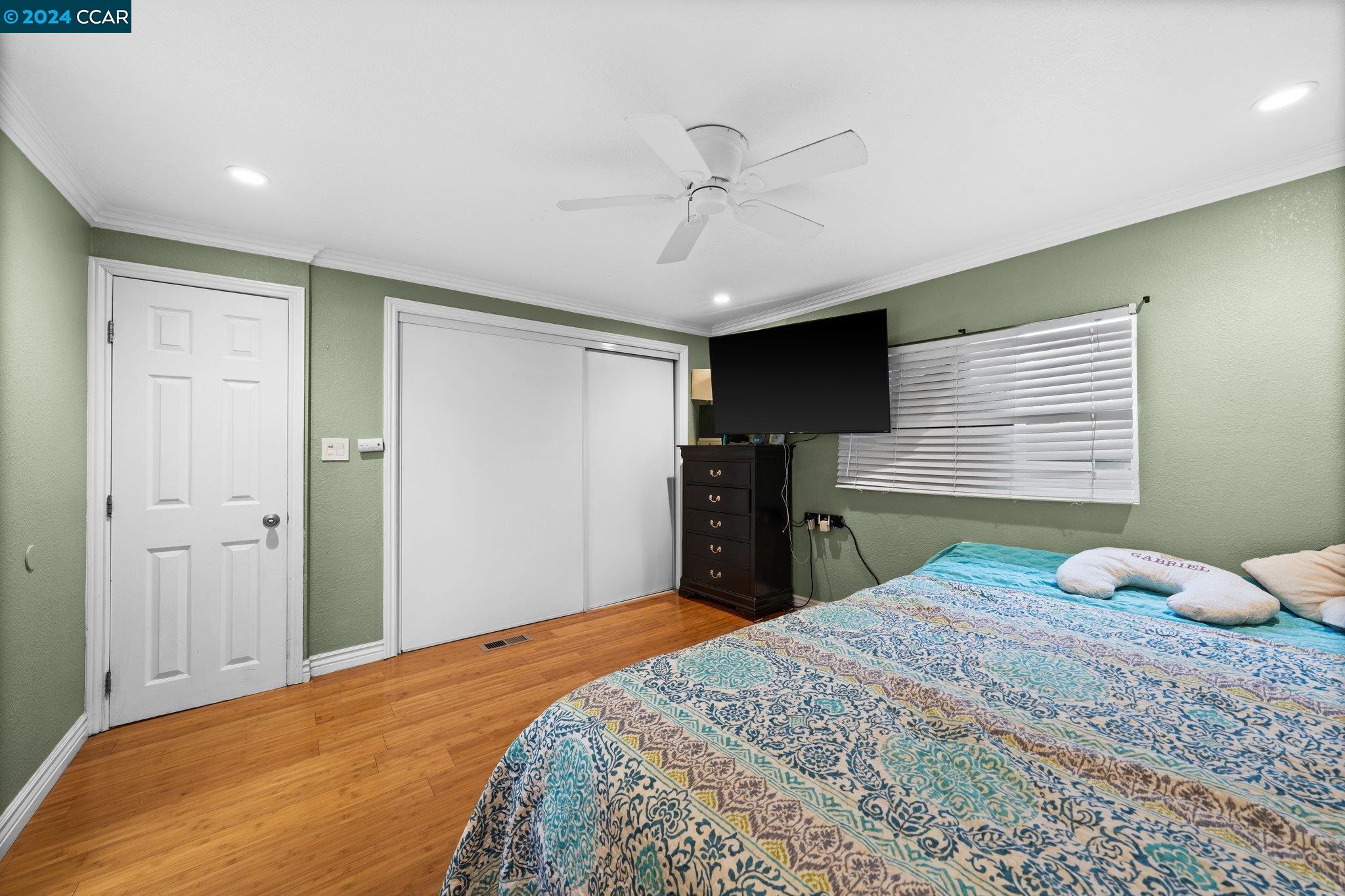 55 Pacifica Avenue, Unit 51 Bay Point, CA 94565 - Photo 21 of 35 a bedroom with a bed and a chandelier