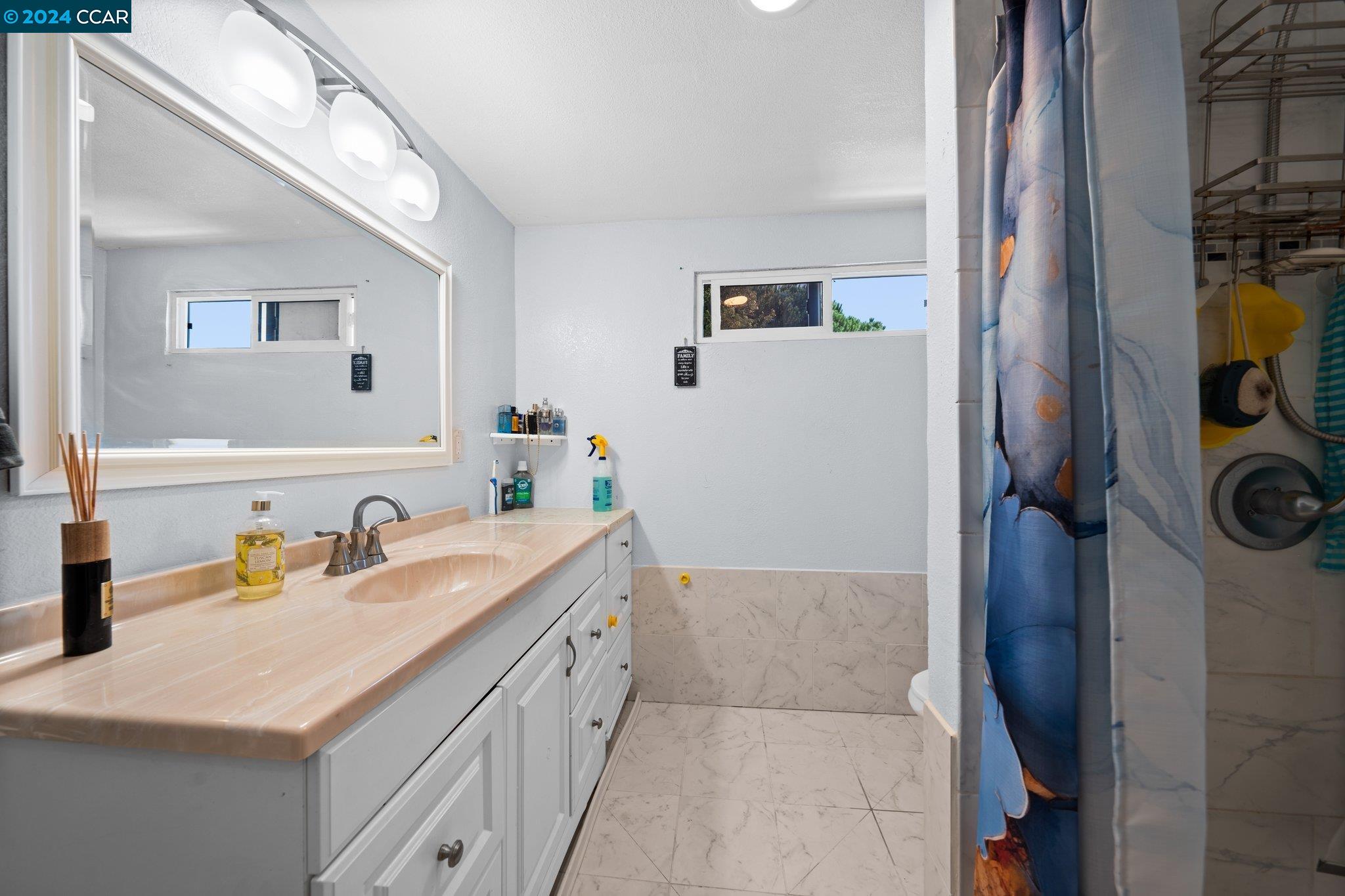 55 Pacifica Avenue, Unit 51 Bay Point, CA 94565 - Photo 22 of 35 a bathroom with a sink and a mirror