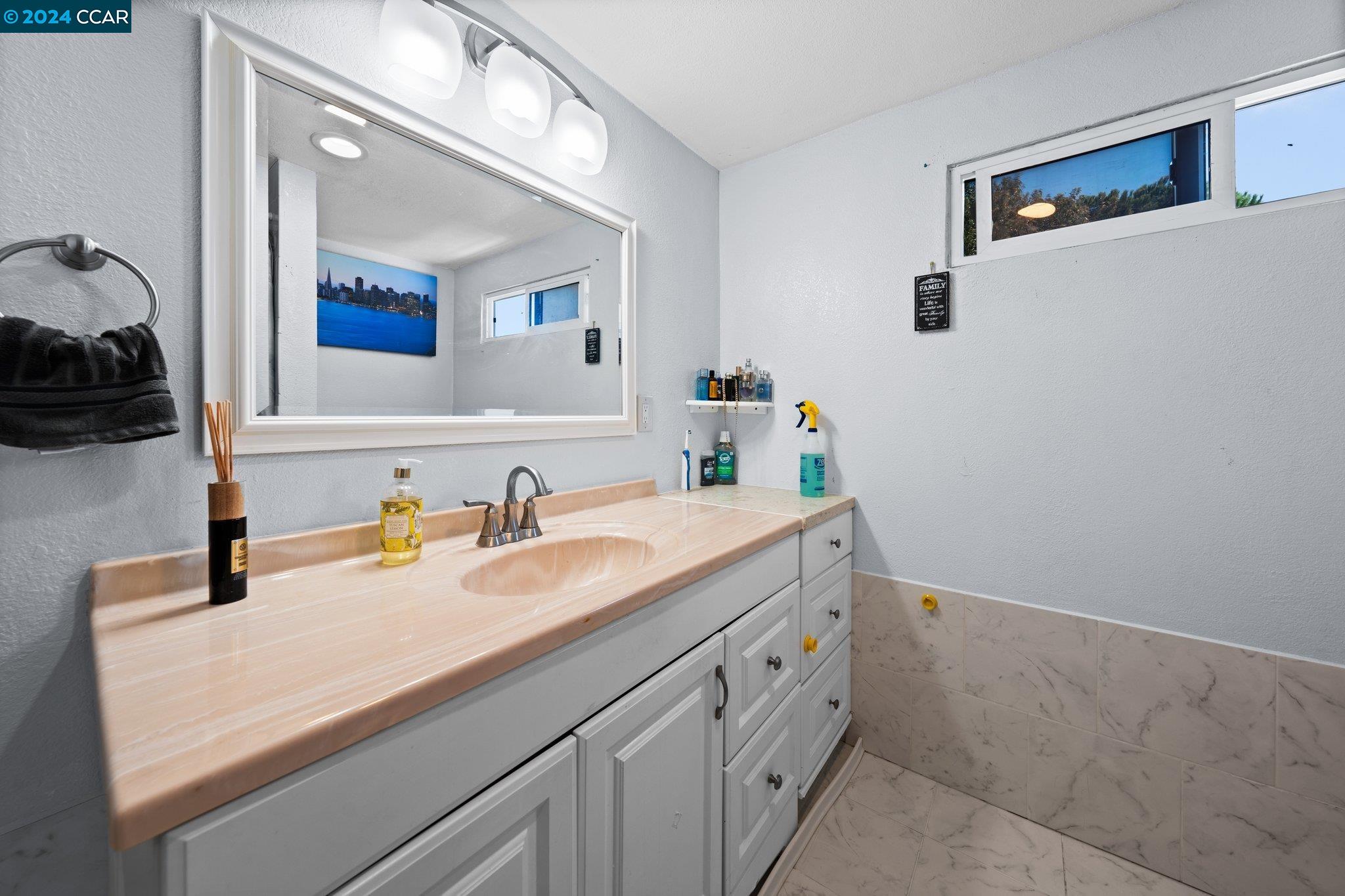 55 Pacifica Avenue, Unit 51 Bay Point, CA 94565 - Photo 23 of 35 a bathroom with a sink and a mirror