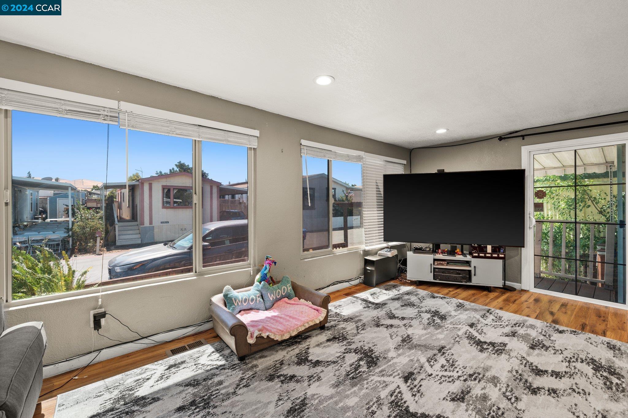 55 Pacifica Avenue, Unit 51 Bay Point, CA 94565 - Photo 4 of 35 a living room with furniture and a flat screen tv