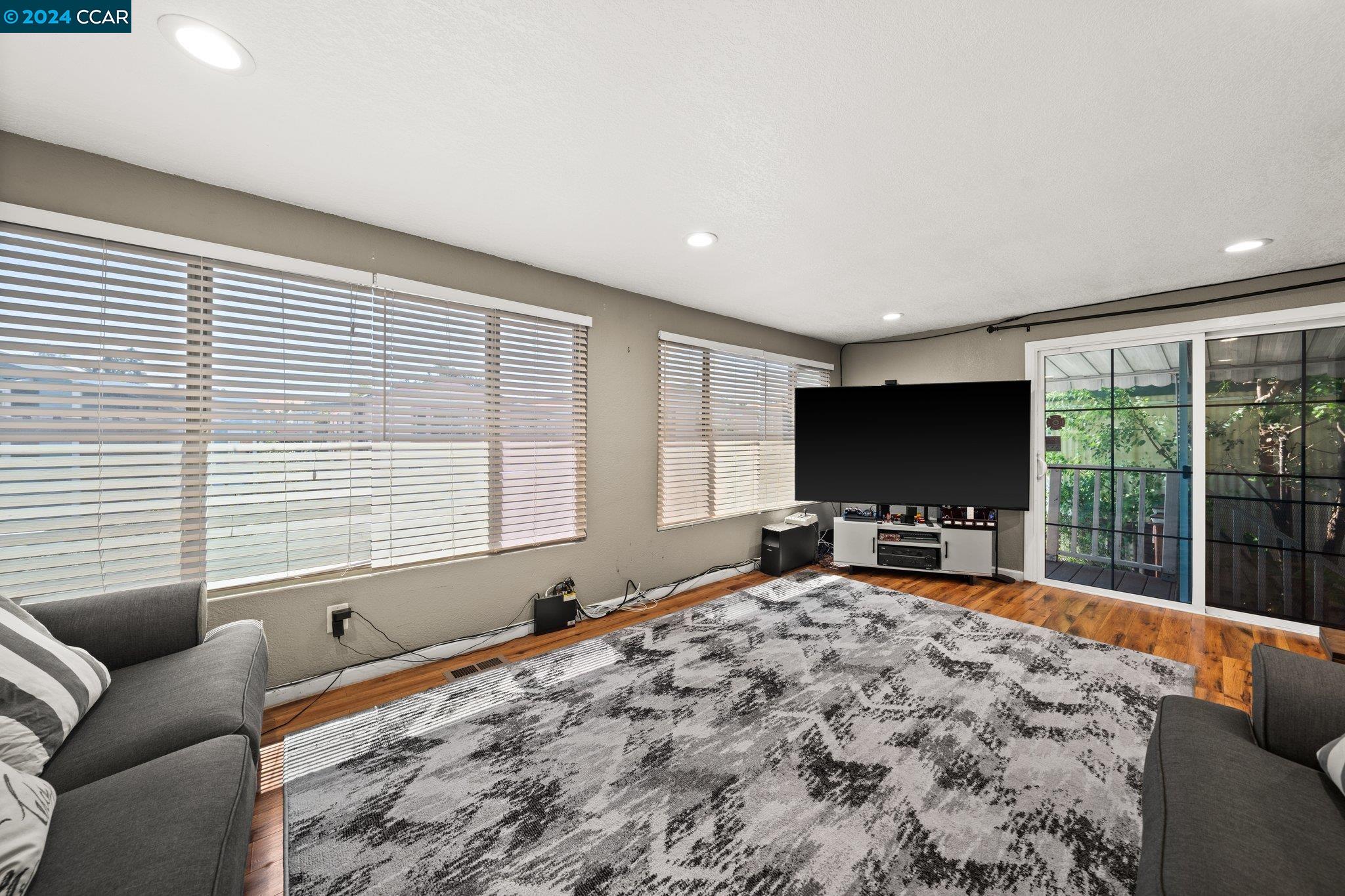 55 Pacifica Avenue, Unit 51 Bay Point, CA 94565 - Photo 8 of 35 a bedroom with furniture tv and large window