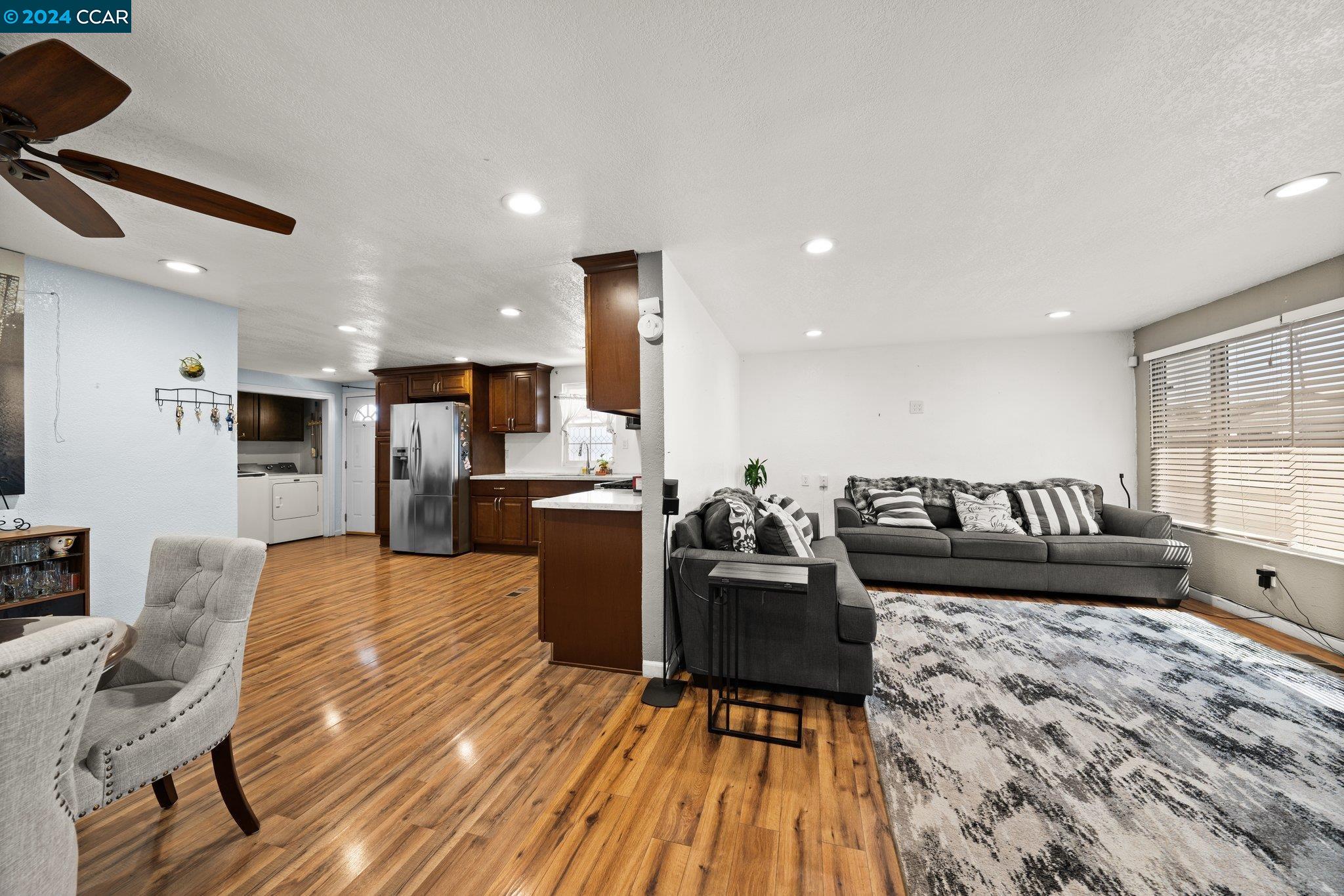 55 Pacifica Avenue, Unit 51 Bay Point, CA 94565 - Photo 9 of 35 a living room with couches and kitchen view with wooden floor