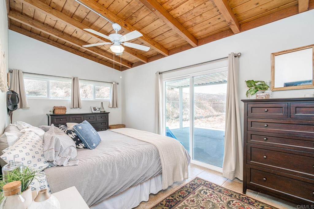 2030 Harbison Canyon Road El Cajon, CA 92019 - Photo 14 of 66 a bedroom with a bed a dresser next to a window