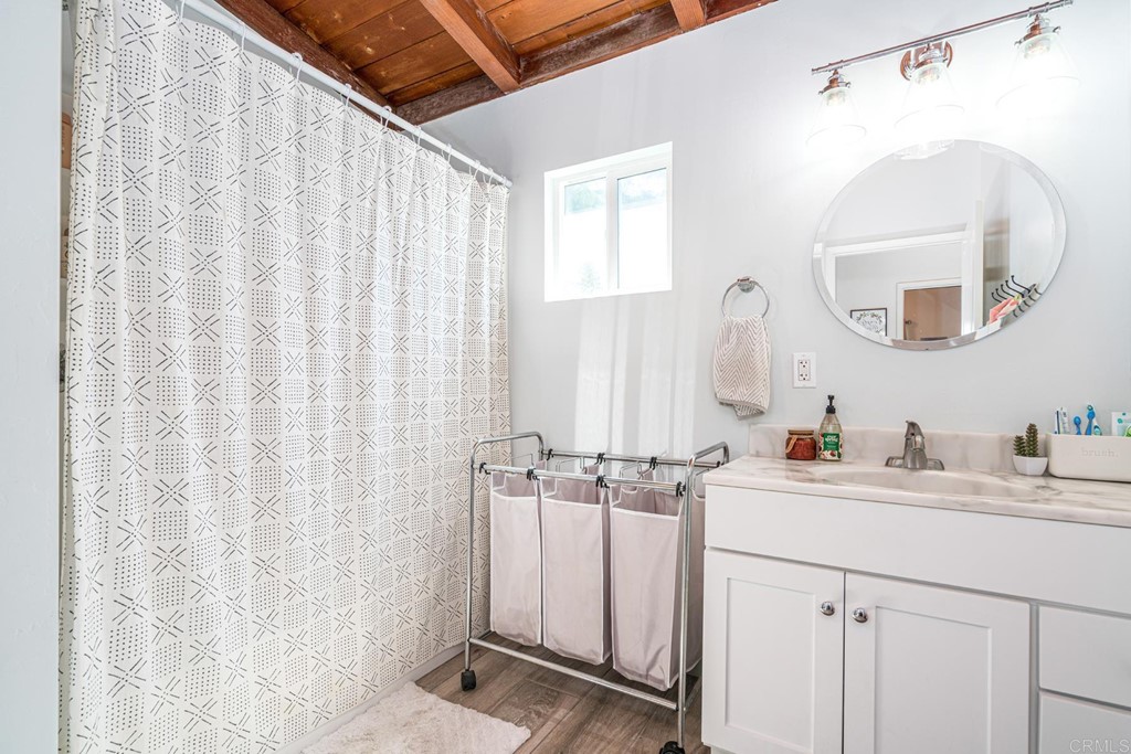 2030 Harbison Canyon Road El Cajon, CA 92019 - Photo 18 of 66 a bathroom with a double vanity sink and a mirror