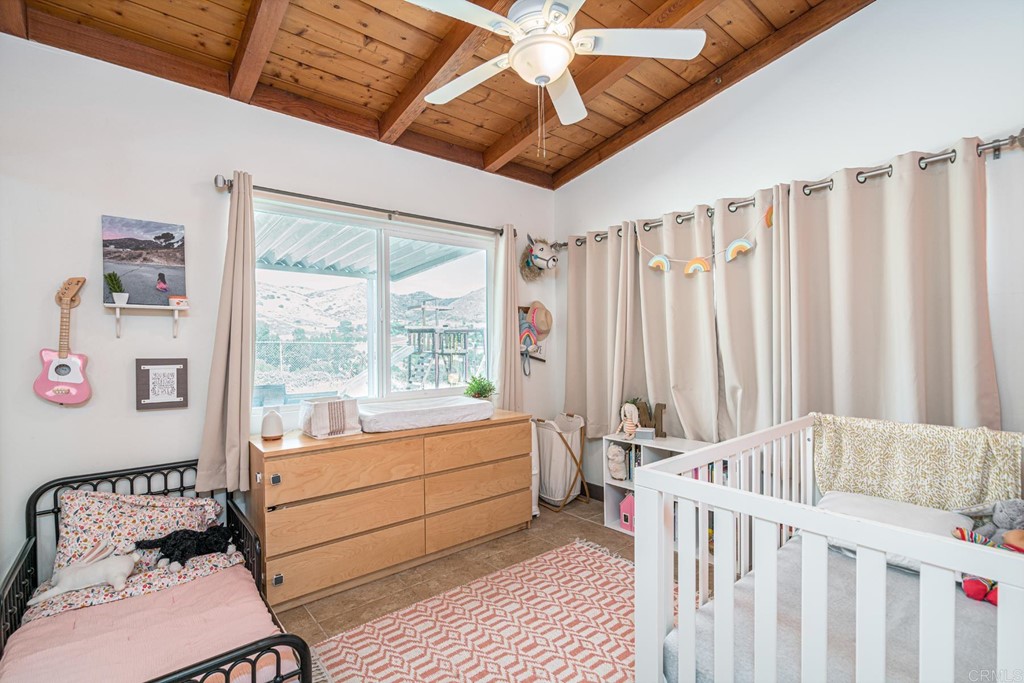 2030 Harbison Canyon Road El Cajon, CA 92019 - Photo 19 of 66 a bedroom with furniture and a window