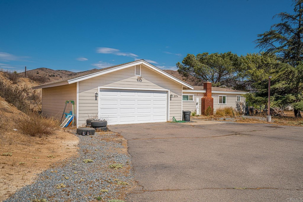 2030 Harbison Canyon Road El Cajon, CA 92019 - Photo 28 of 66 a view of a house with a yard and garage