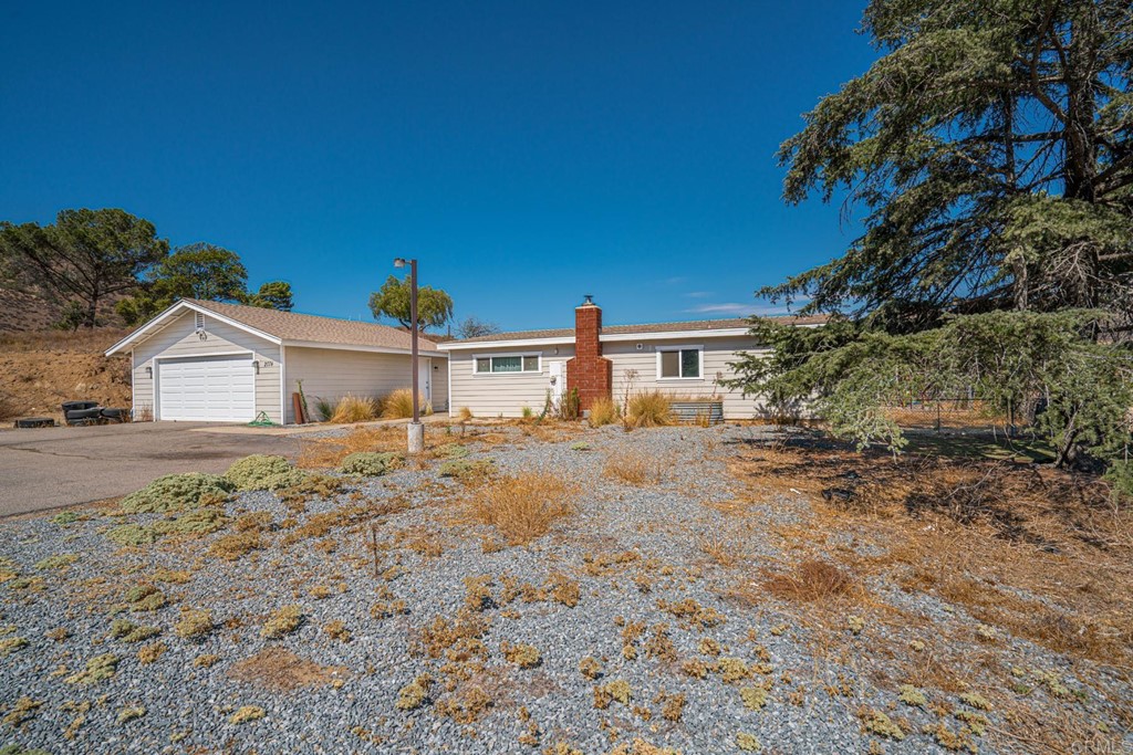 2030 Harbison Canyon Road El Cajon, CA 92019 - Photo 30 of 66 a front view of a house with a yard