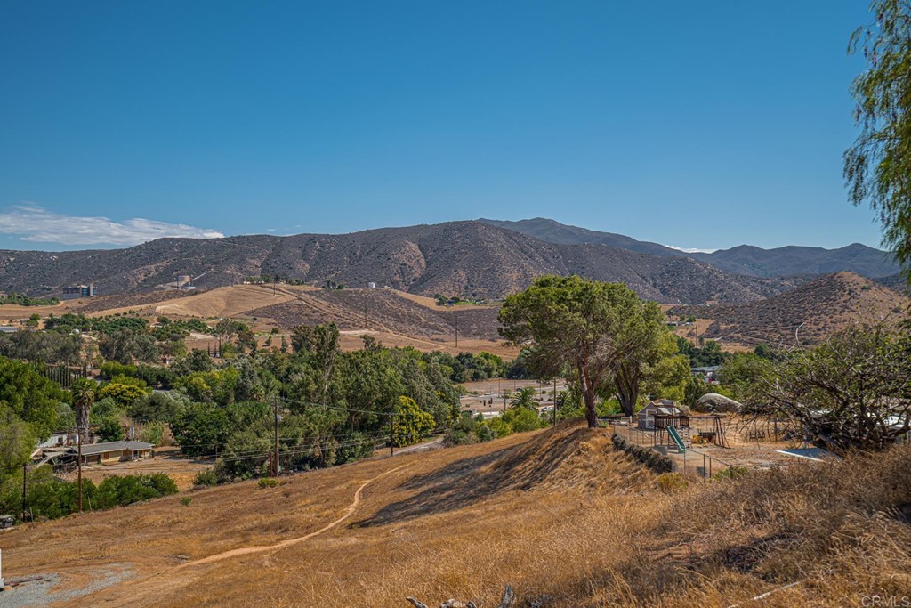 2030 Harbison Canyon Road El Cajon, CA 92019 - Photo 35 of 66 a view of a dry yard with mountains in the background