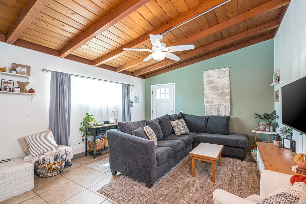 2030 Harbison Canyon Road El Cajon, CA 92019 - Photo 5 of 66 a living room with furniture a ceiling fan and a window