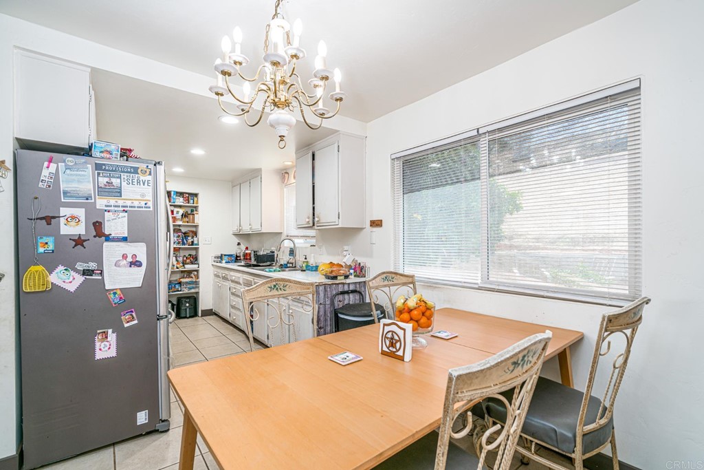 2030 Harbison Canyon Road El Cajon, CA 92019 - Photo 41 of 66 a kitchen with stainless steel appliances a table and chairs