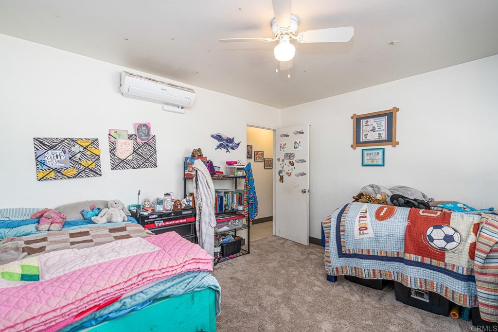 2030 Harbison Canyon Road El Cajon, CA 92019 - Photo 49 of 66 a bedroom with a bed and a chandelier