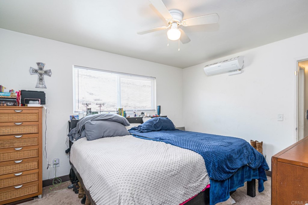 2030 Harbison Canyon Road El Cajon, CA 92019 - Photo 51 of 66 a bedroom with a bed and a chandelier