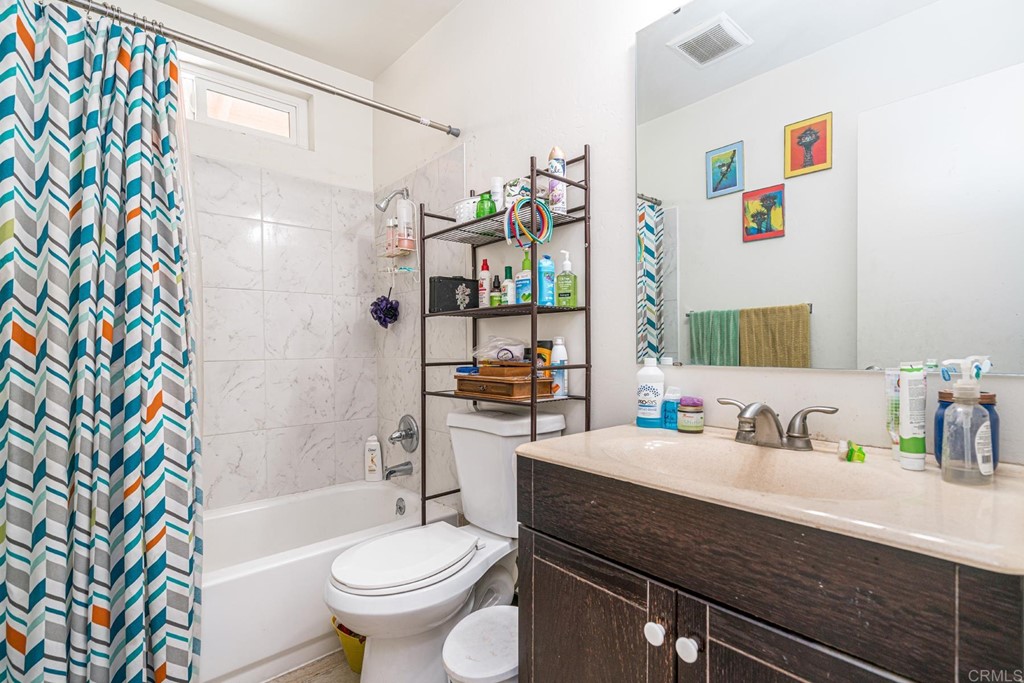 2030 Harbison Canyon Road El Cajon, CA 92019 - Photo 52 of 66 a bathroom with a sink a toilet and shower curtain