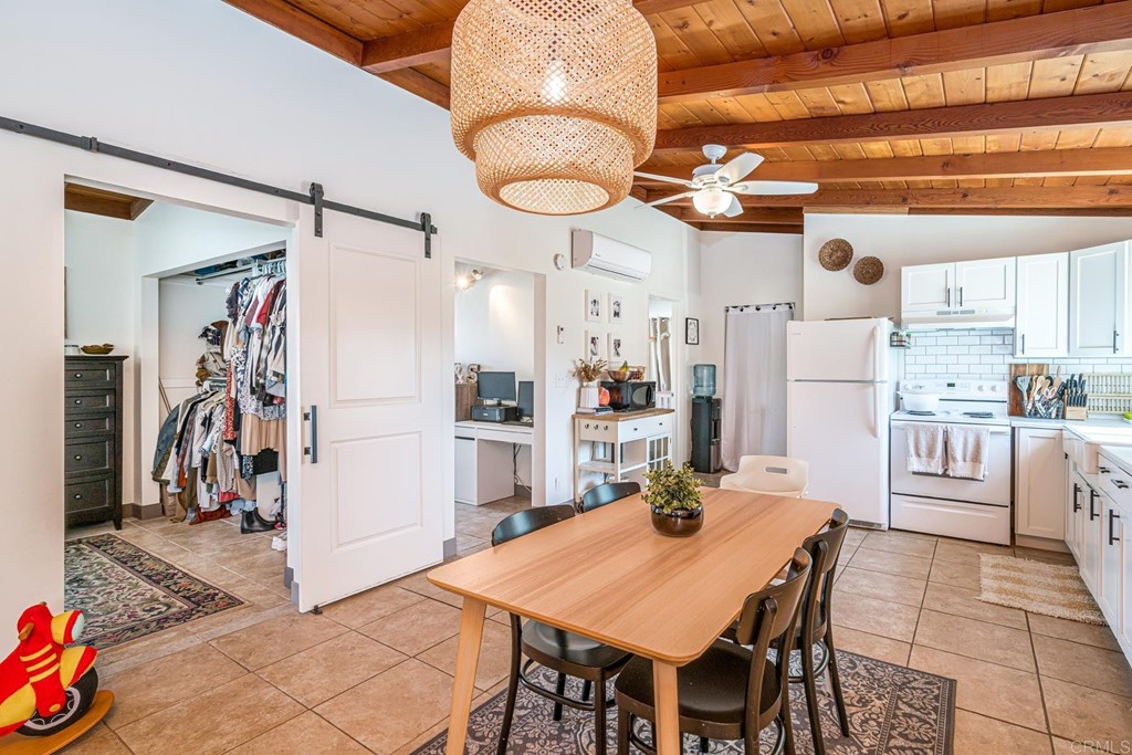 2030 Harbison Canyon Road El Cajon, CA 92019 - Photo 7 of 66 a kitchen with stainless steel appliances kitchen island granite countertop a table chairs and a refrigerator