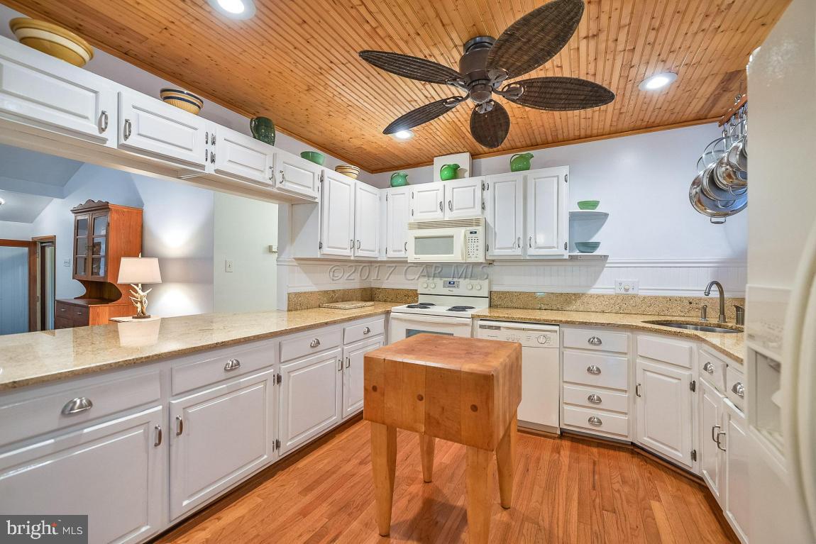 27 Brookside Road Ocean Pines, MD 21811 - Photo 18 of 44 a kitchen with stainless steel appliances granite countertop a sink a stove and cabinets