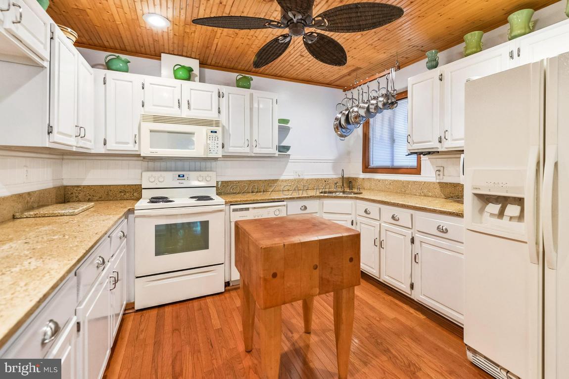 27 Brookside Road Ocean Pines, MD 21811 - Photo 19 of 44 a kitchen with cabinets stainless steel appliances and wooden floor