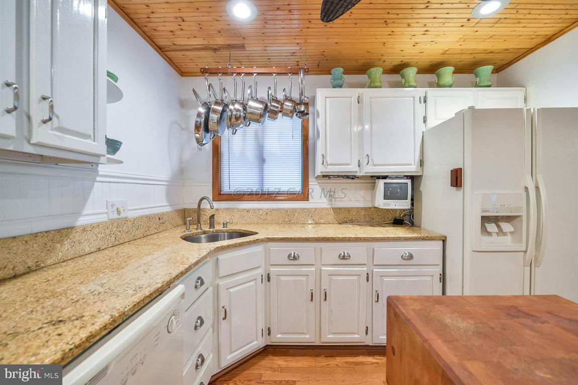27 Brookside Road Ocean Pines, MD 21811 - Photo 20 of 44 a kitchen with granite countertop a sink a counter space and cabinets