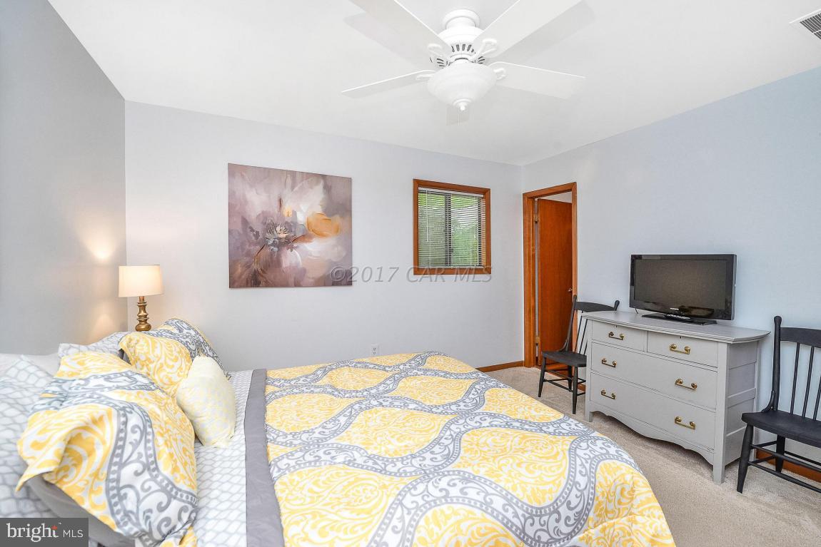 27 Brookside Road Ocean Pines, MD 21811 - Photo 24 of 44 a bedroom with a bed and a flat screen tv