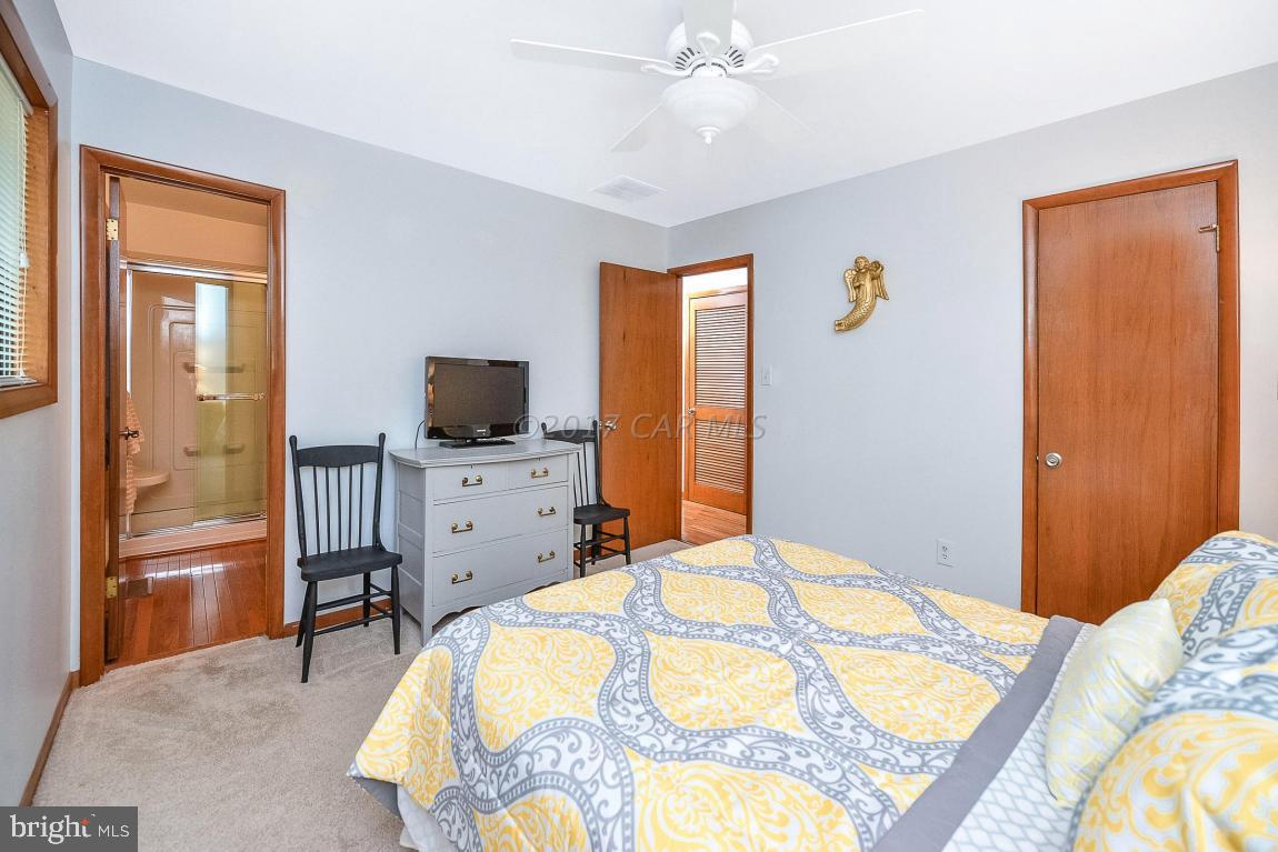 27 Brookside Road Ocean Pines, MD 21811 - Photo 25 of 44 a bedroom with a bed and flat screen tv