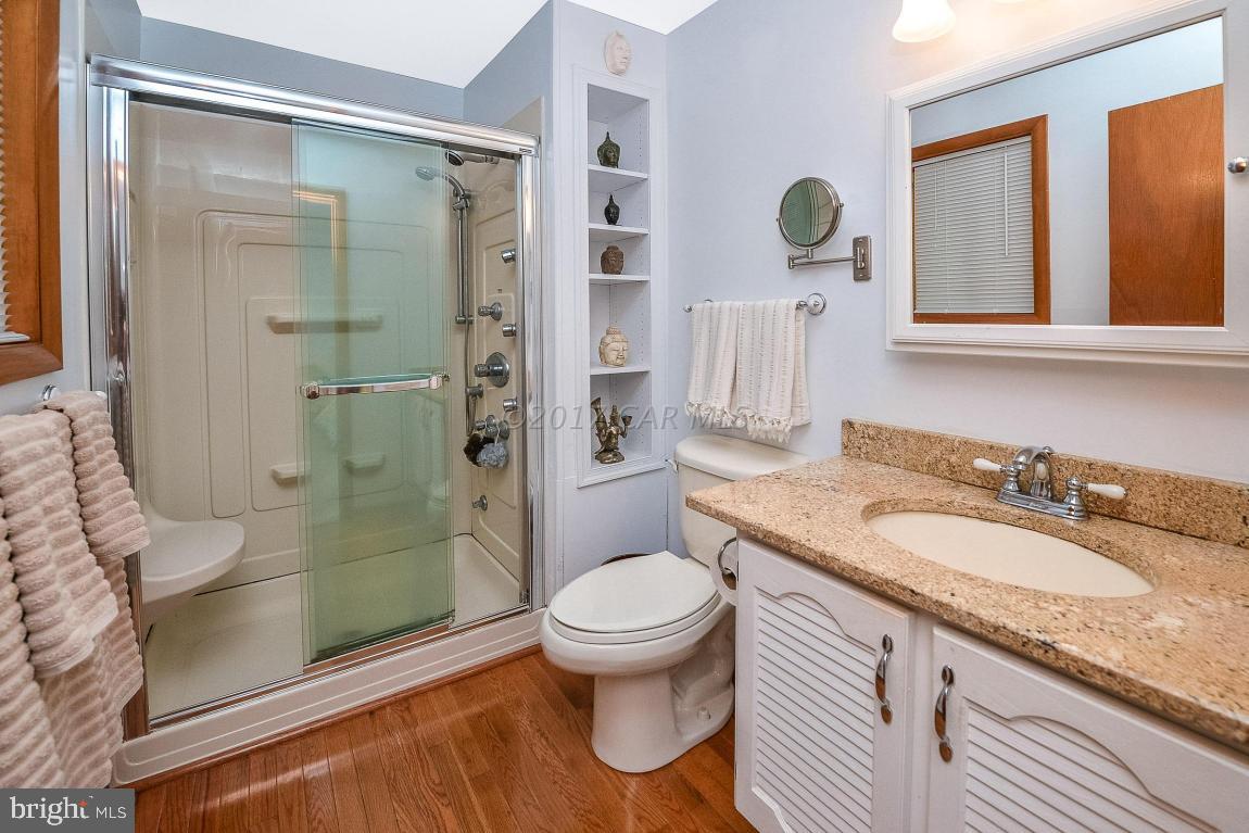 27 Brookside Road Ocean Pines, MD 21811 - Photo 26 of 44 a bathroom with a granite countertop sink toilet and shower