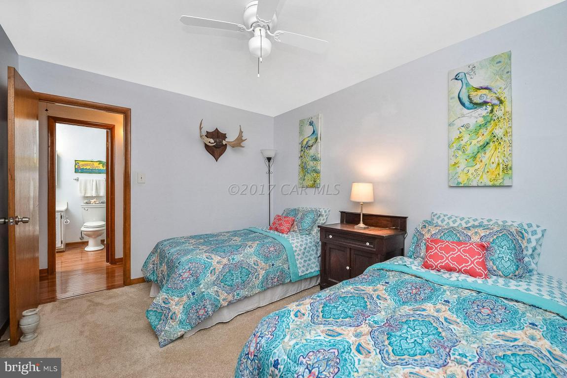 27 Brookside Road Ocean Pines, MD 21811 - Photo 30 of 44 a bedroom with a bed and wooden floor