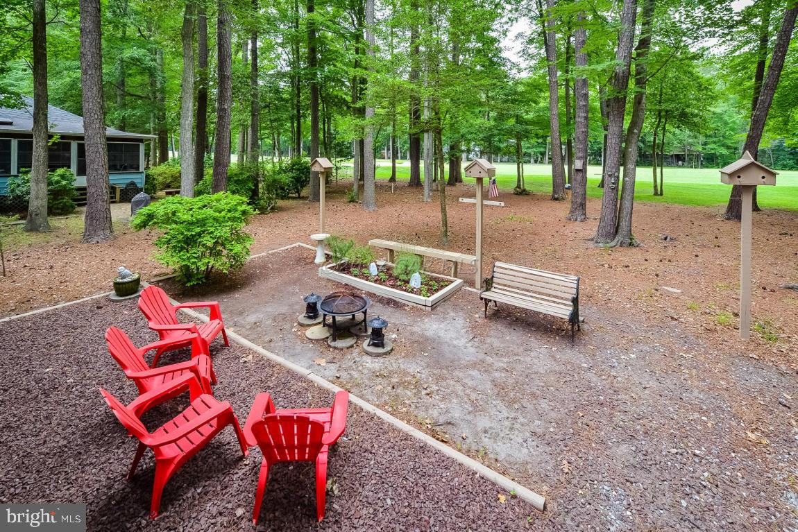 27 Brookside Road Ocean Pines, MD 21811 - Photo 40 of 44 an outdoor sitting area with lots of trees