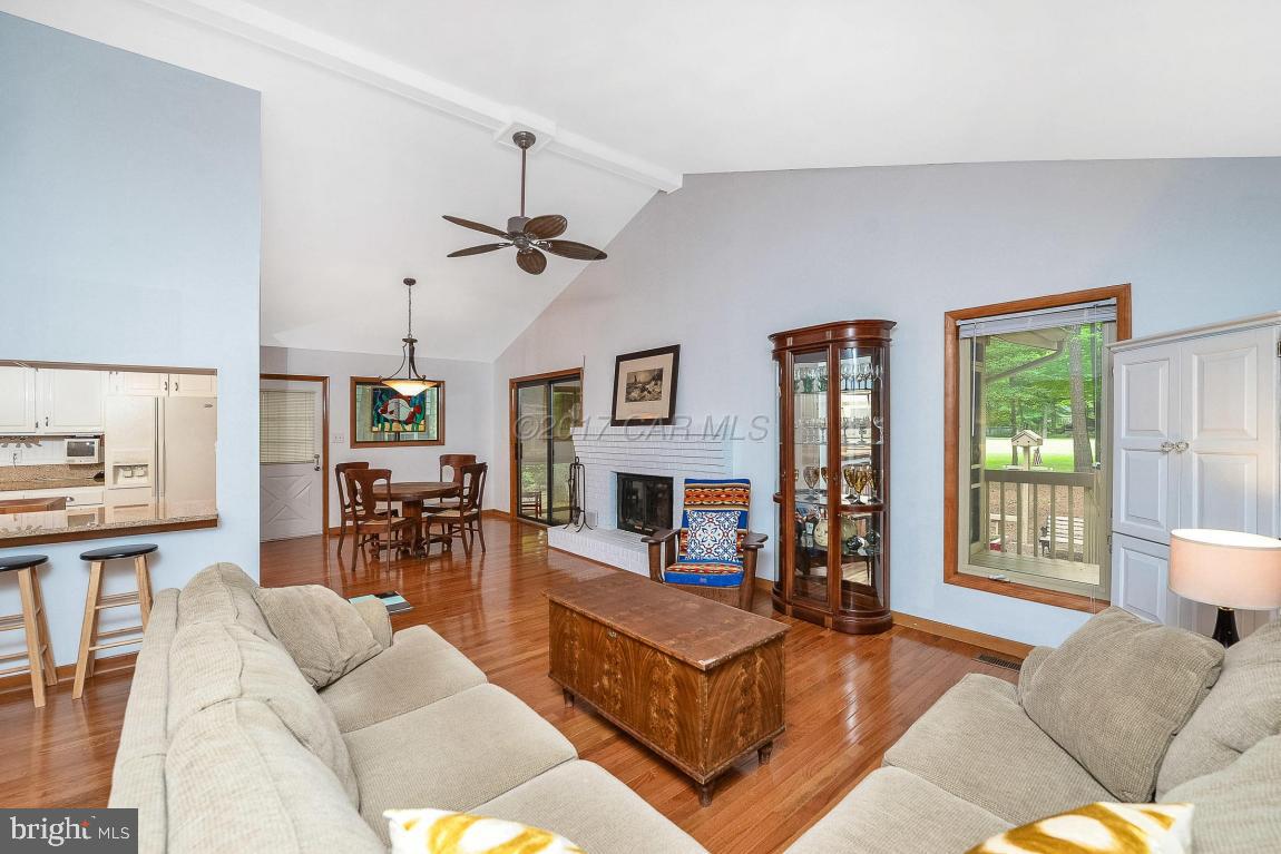 27 Brookside Road Ocean Pines, MD 21811 - Photo 6 of 44 a living room with furniture a fireplace and a table