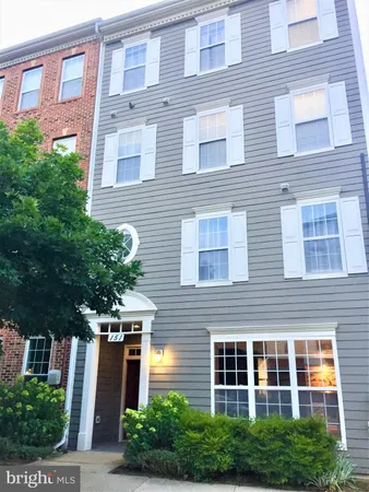 a front view of a building with plants