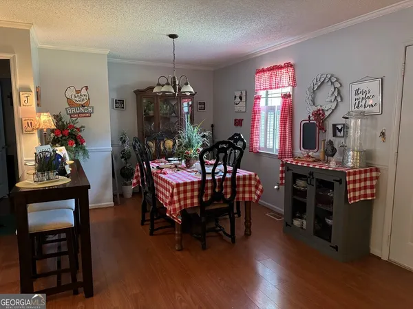 a view of a dining room with furniture and chandelier