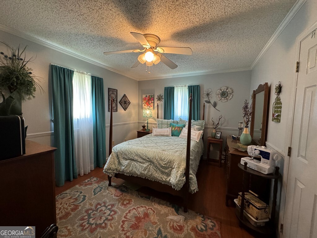 2014 Davis Avenue Tifton, GA 31794 - Photo 8 of 18 a bedroom with a bed and a chandelier
