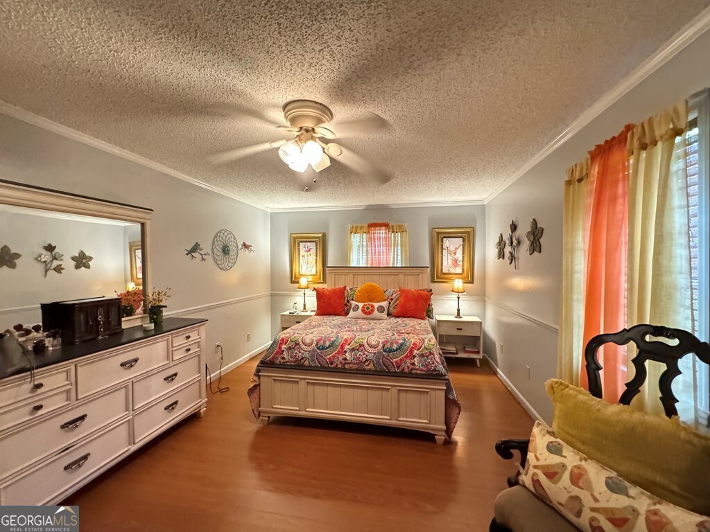 2014 Davis Avenue Tifton, GA 31794 - Photo 9 of 18 a bedroom with a bed and wooden floor