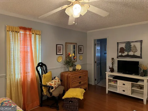 a living room with furniture and flat screen tv