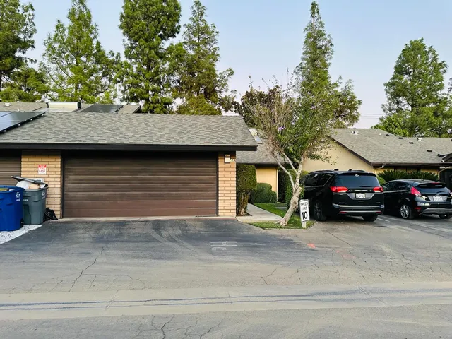 a view of a car parked in front of a house