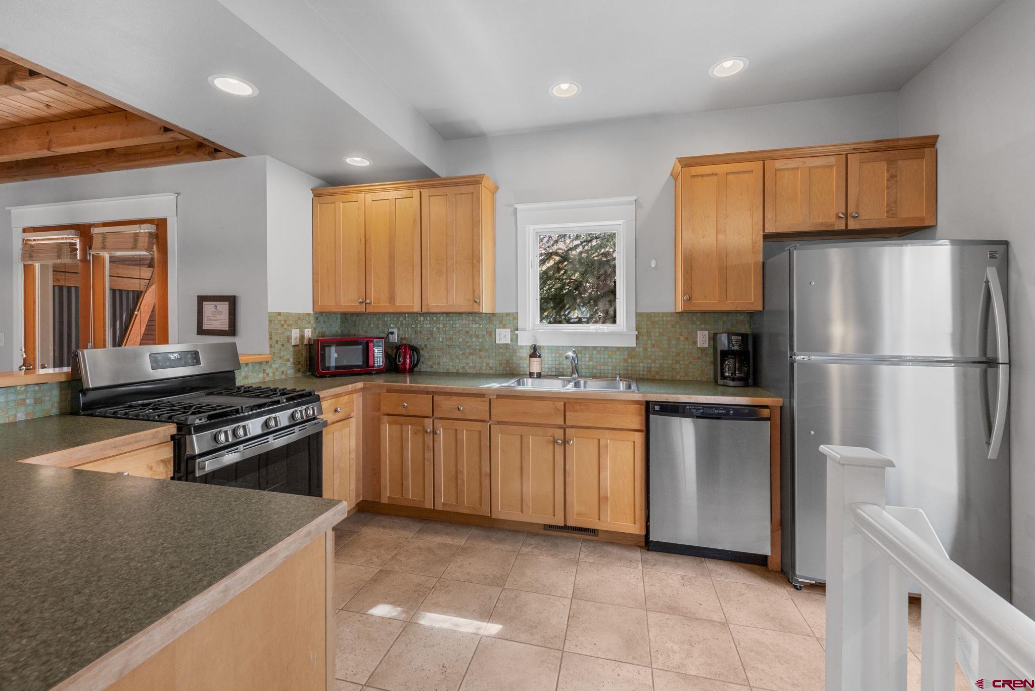 205 Horseshoe Crested Butte, CO 81225 - Photo 14 of 28 a kitchen with granite countertop a refrigerator stove top oven and sink