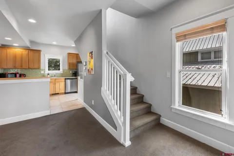 a view of a room with a baby crib and a window