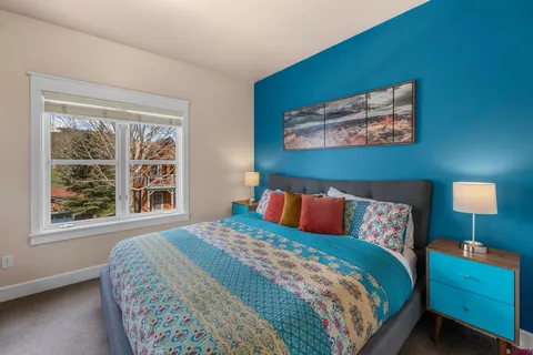 a bathroom with a granite countertop sink mirror vanity and toilet