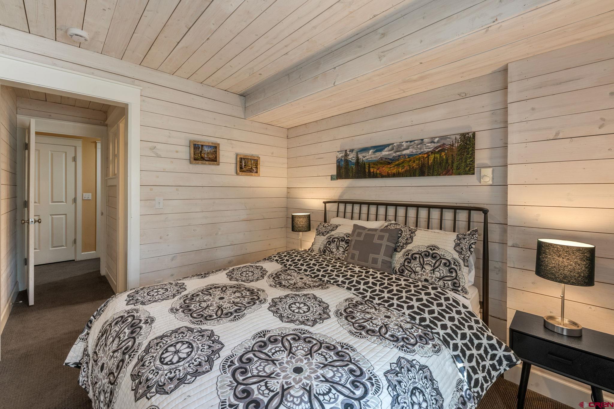 205 Horseshoe Crested Butte, CO 81225 - Photo 26 of 28 a bedroom with a bed and a tv