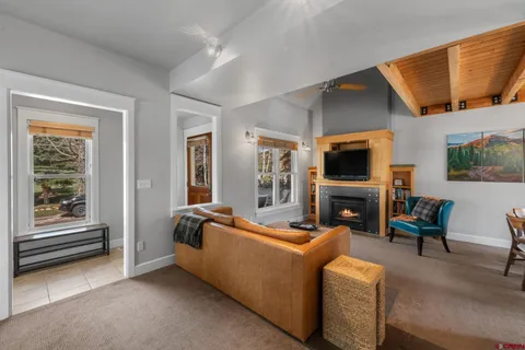 a living room with fireplace furniture and a flat screen tv